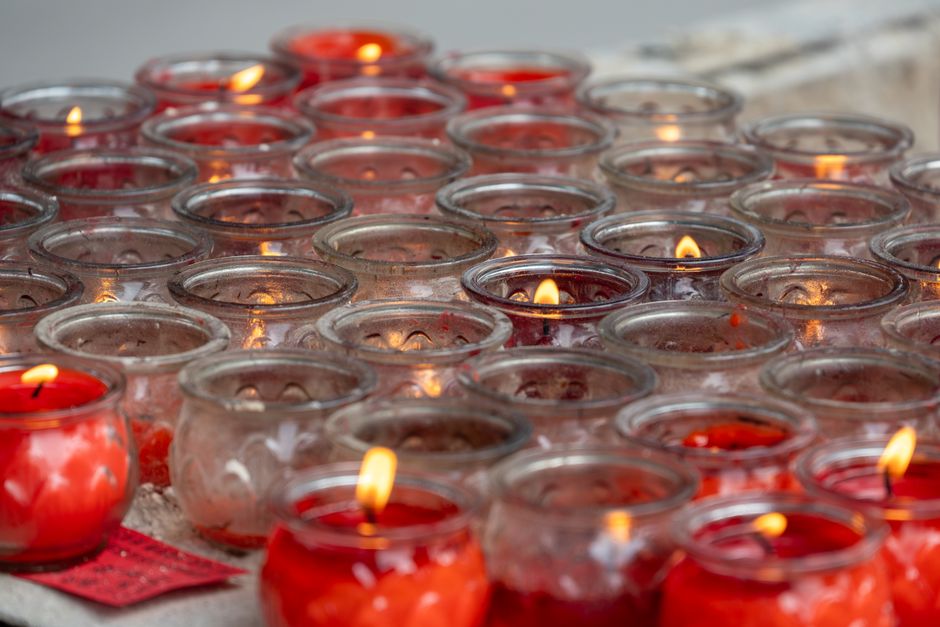 Red candles in glass holders create a warm, serene atmosphere, ideal for contemplative moments.