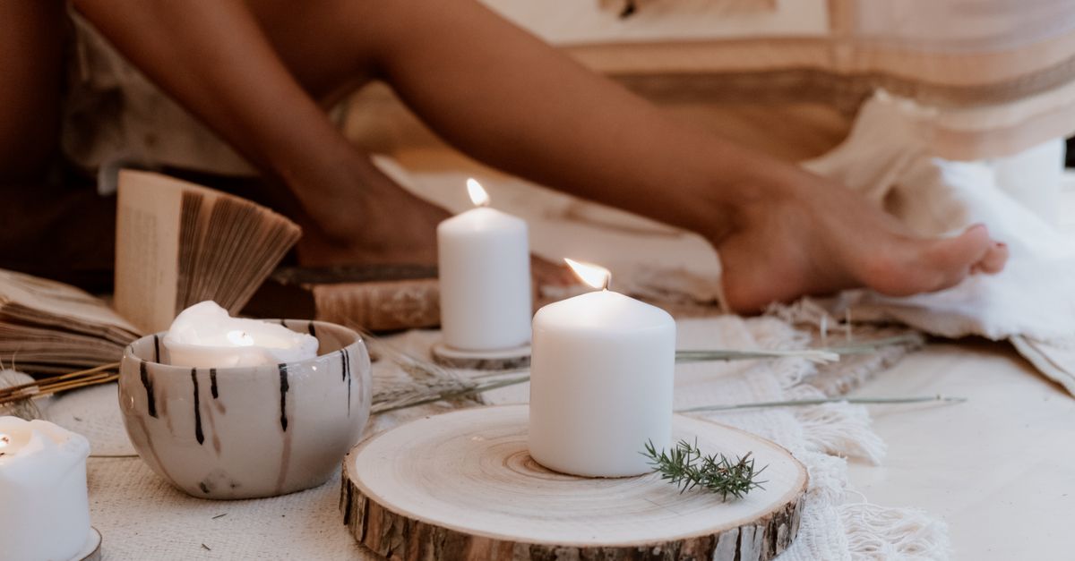 A serene indoor setting featuring candles and an open book for relaxation.