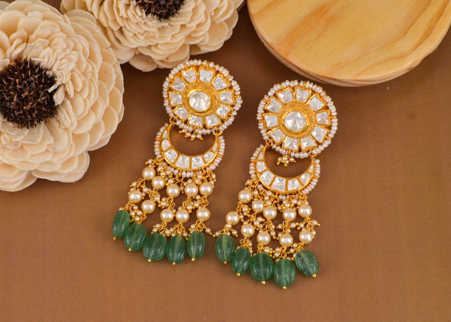 Gold earrings adorned with pearls and green gemstones, perfect for a luxurious gift.